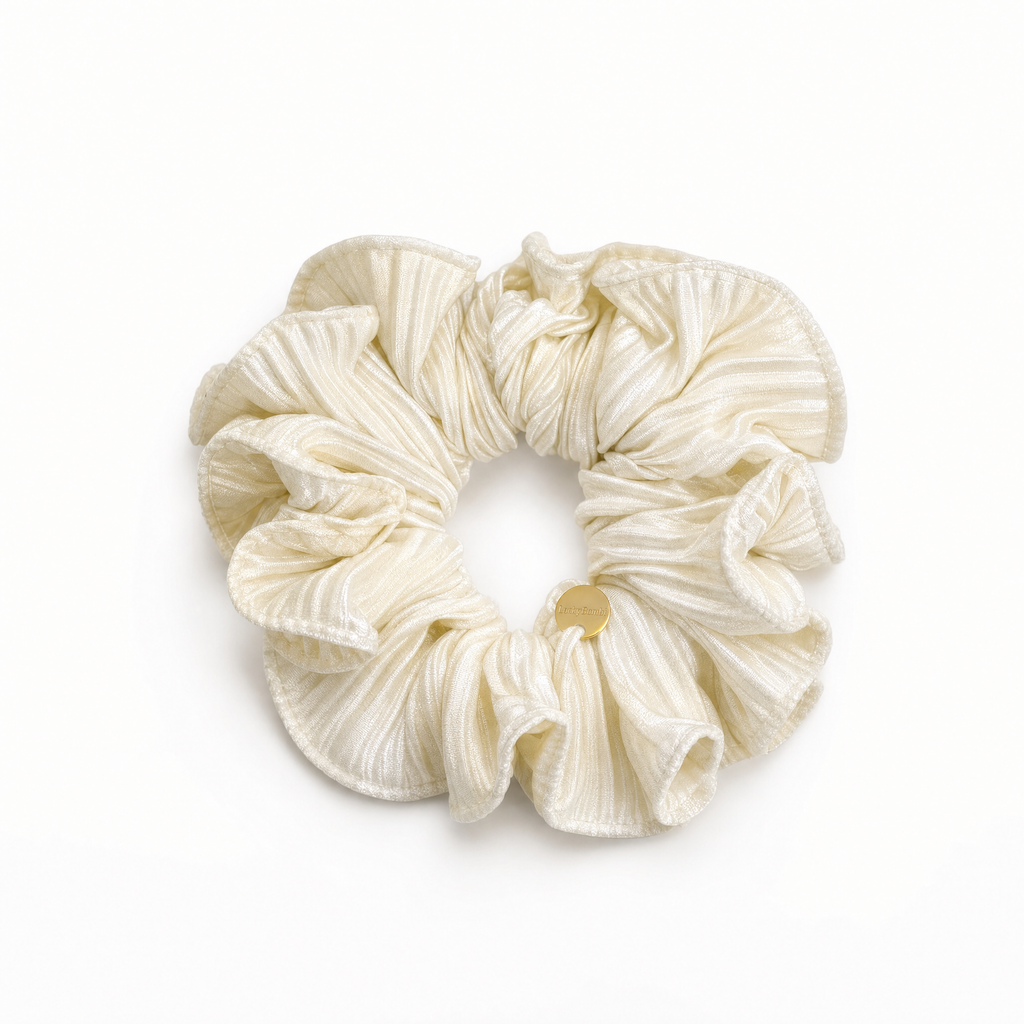 Soft cream satin hair scrunchie with smooth high-shine fabric for crease-free hair hold
