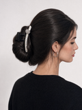 Back view of model with long dark hair secured in a bridal-inspired French twist using a white pearl hair claw clip