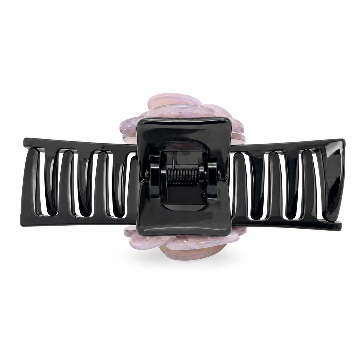 Flat-lay top view of a sparkly pink camellia flower claw clip showcasing the marbled resin finish and rhinestone center