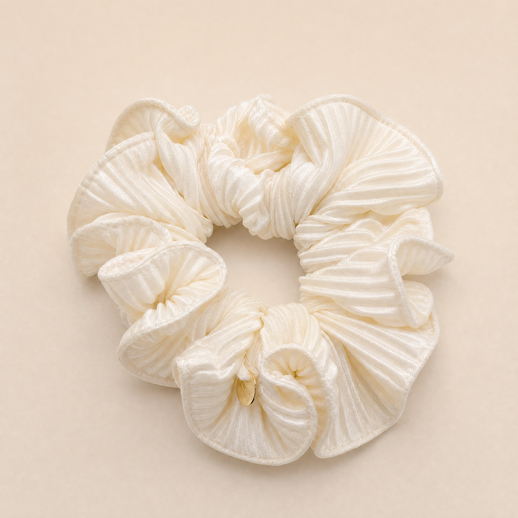 Soft cream satin hair scrunchie with smooth high-shine fabric for crease-free hair hold