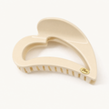 Soft buttermilk yellow heart-shaped claw clip with smooth resin finish and strong-hold teeth