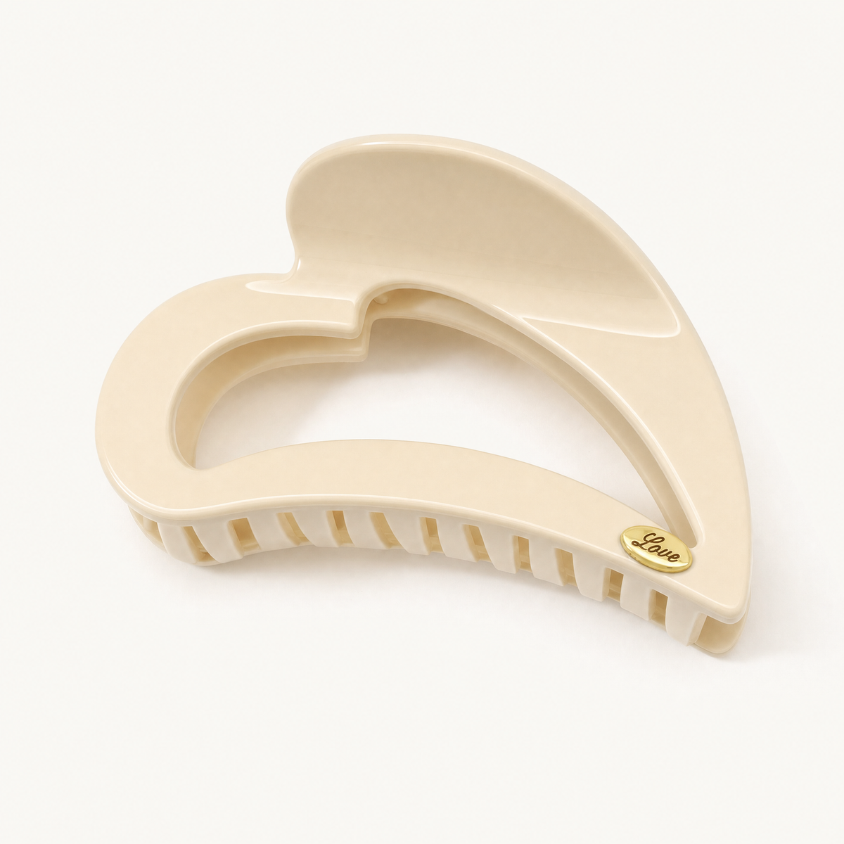 Soft buttermilk yellow heart-shaped claw clip with smooth resin finish and strong-hold teeth