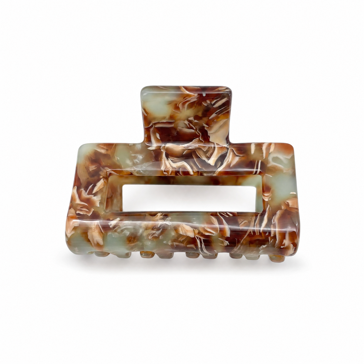 Warm honey tortoiseshell French medium claw clip on a neutral stone surface
